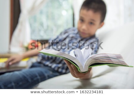 Stock photo: Blurred Of Cheerful Young Student Standing Holding Book And Read