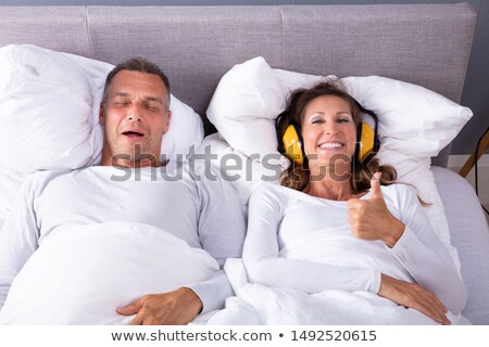 Zdjęcia stock: Woman Covering Her Ears With Headphone Showing Thumb Up Sign