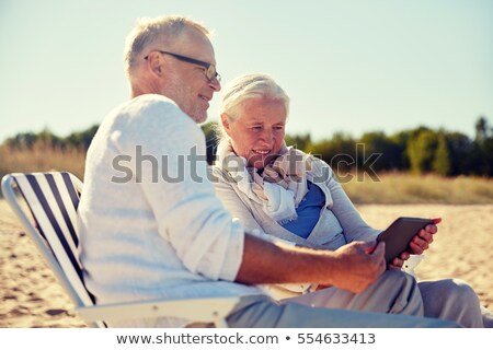 Stock photo: Man Relaxing On Vacation Chaise Longue By Seaside