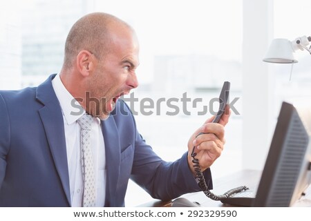 Stok fotoğraf: Angry Bald Businessman Holding Telephone