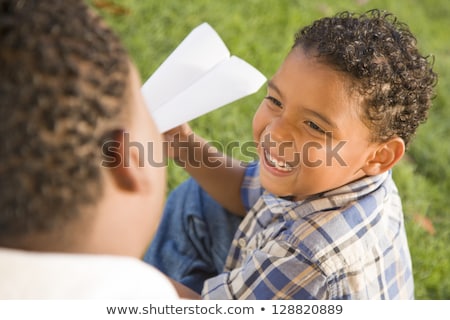 [[stock_photo]]: Mixed Race Father And Son Playing With Paper Airplanes