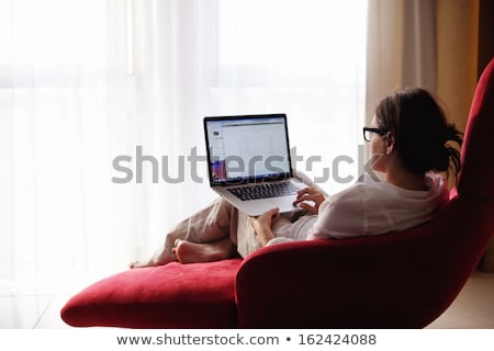 Brunette Using Laptop On Sofa [[stock_photo]] © dotshock