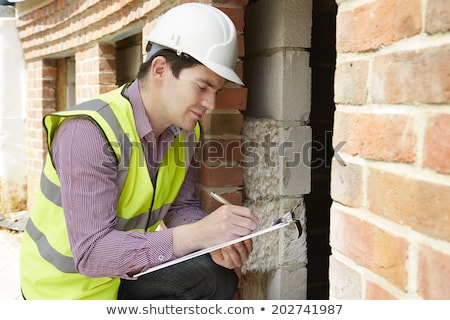 [[stock_photo]]: Architect Checking Insulation During House Construction