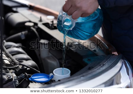 Stock photo: Hand Holding A Bottle Of Antifreeze