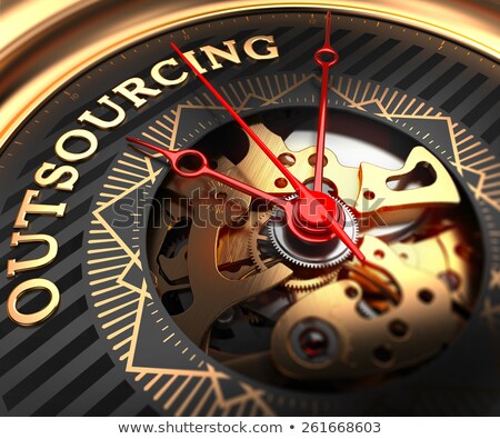 Foto stock: Outsourcing On Black Golden Watch Face