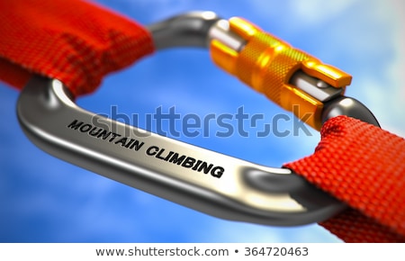 Foto stock: Challenge On Chrome Carabiner Between Red Ropes