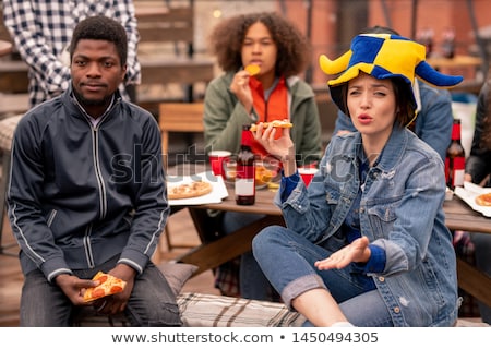 ストックフォト: Young Intercultural Football Fans Watching Broadcast In Outdoor Cafe