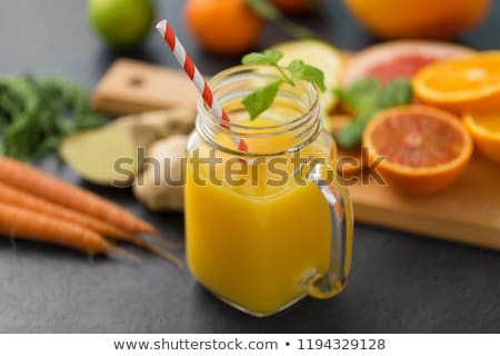 Foto stock: Mason Jar Glass Of Fruit Juice On Slate Table Top