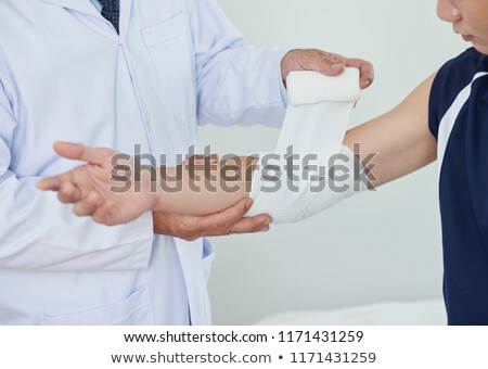 Zdjęcia stock: Crop Doctor Bandaging Elbow Of Patient