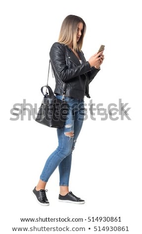 Foto d'archivio: Pretty Young Woman Standing With Mobile Phone On Street At Autum