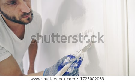 Stok fotoğraf: Man Painting Around Paint Switch