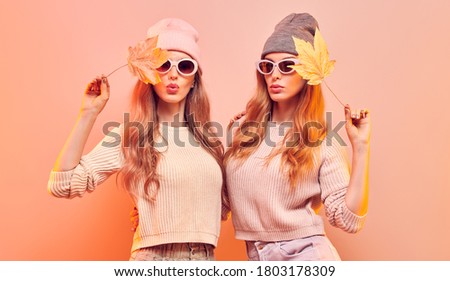 Stockfoto: Two Girls In Orange Outfit