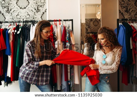 Stock fotó: Emotionaly Women Holding One Red Dress In Hands Together And Angry Pull It