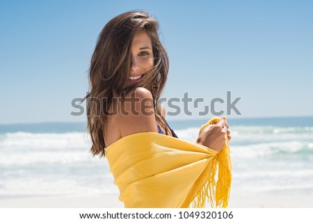 Stock photo: Happy Woman With Yellow Sarong On The Beach