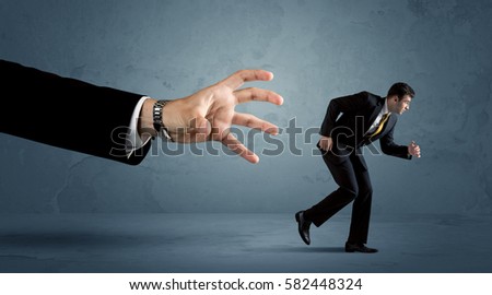 ストックフォト: Business Man Running From A Big Hand