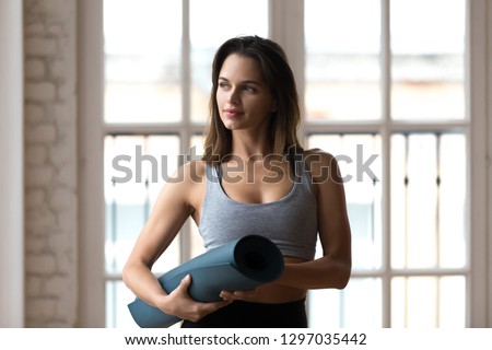 Stock photo: Young Woman Carrying Exercising Mat Thinking