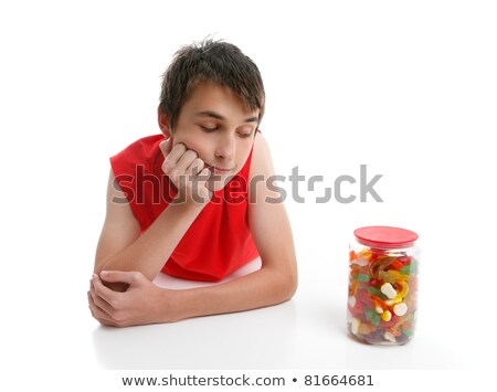 Stock fotó: Boy Ponders To Open Jar Confectionery