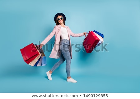 Stockfoto: Photo Of Young Joyful Woman With Shopping Bags On The Background