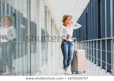 Foto stock: Young Pretty Stylish Woman With Luggage At The International Air