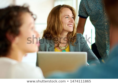 Foto stock: Three People In Animated Business Meeting