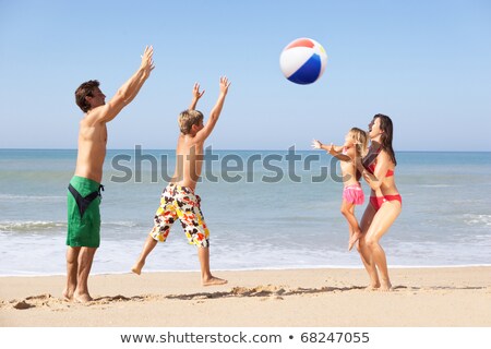 ストックフォト: Boy Enjoys Playing Ball At The Beach