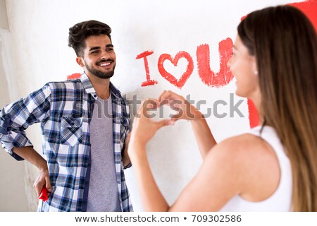 Stockfoto: Young Beautiful Woman Painting Hew New Home