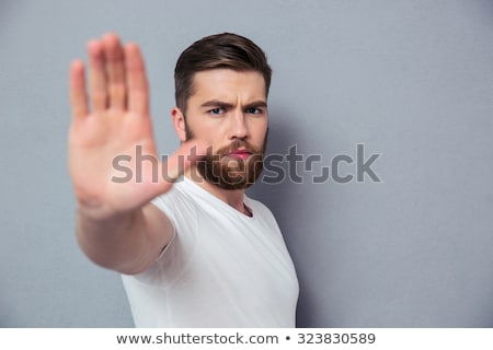 Foto stock: A Handsome Young Man Showing A Hand Signal