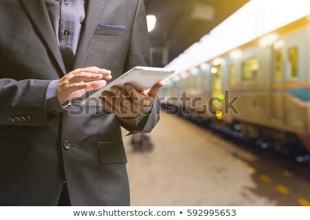 Stockfoto: Businessman With Touchpad At Train Station