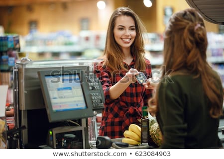 Stock photo: Cashier Standing At The Checkout In Supermarket