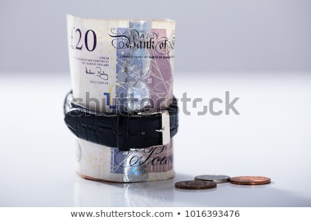 Foto d'archivio: Rolled Up Twenty Pounds Currency Note Inside The Wrist Watch