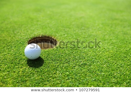 Сток-фото: Golf Ball On Lip Of Cup