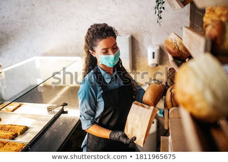 Stock fotó: The Young Female Baker Working In Kitchen