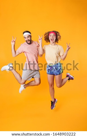 Stock foto: Full Length Image Of Athletic Happy Couple Clenching Fists In Tr