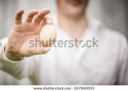 Stock photo: Old Man Holding An Egg