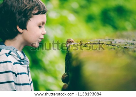 ストックフォト: A Young Boy With A Snail