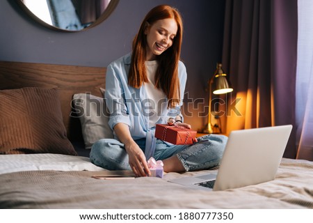 Stock photo: Young Woman Sitting On The Bed
