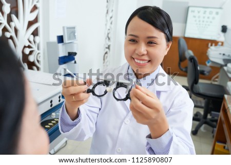 Сток-фото: Cheerful Ethnic Oculist Working With Patient