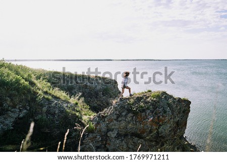 Stock foto: Rear View Of Caucasian Woman Standing On Beach While Looking At Camera And Holding Hand On A Sunny D