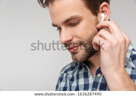 Stock foto: Portrait Closeup Of Pleased Young Man Using Earphones