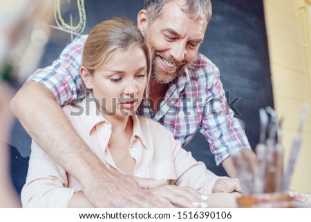 Stock fotó: Happy Male And Female Potter Painting Bowl