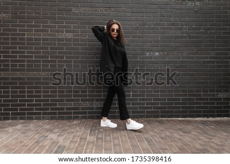 Beautiful Girl Walks In The City Near The Black Wall In The Rain Stok fotoğraf © Alones