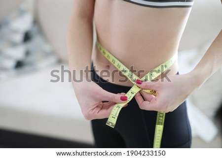 Foto d'archivio: Woman Holding Meter Measuring Perfect Shape Of Her Beautiful Body