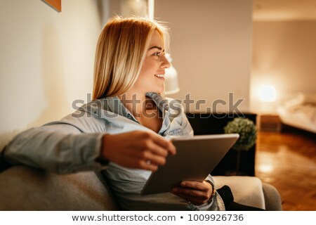ストックフォト: Smiling Woman Using A Touchscreen Tablet