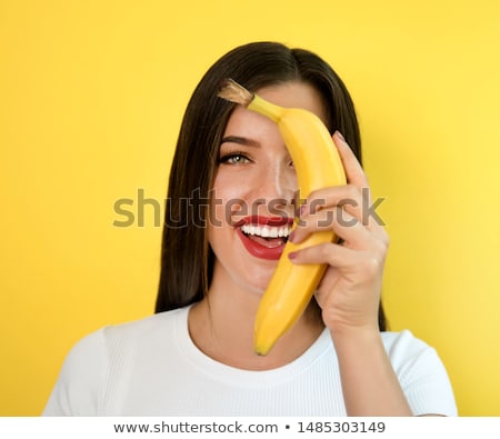 Stockfoto: Beautiful Brunette Holds A Banana