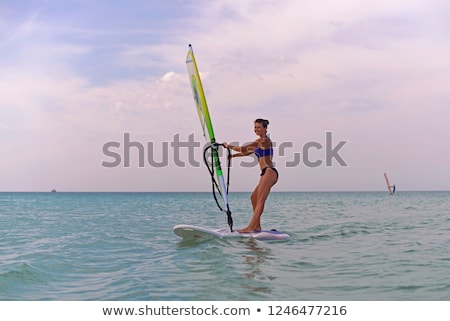 Stock photo: Happy Woman With Wind Surf On The Beach