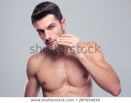 Foto stock: Man Cleaning Face Skin With Batting Cotton Pads