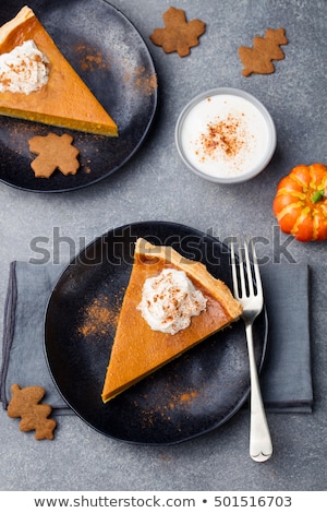 Stok fotoğraf: Pumpkin Pie Tart Made For Thanksgiving Day With Whipped Cream On A Black Plate Top View