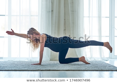 Foto stock: Pregnant Woman Practicing Yoga Exercise At Home