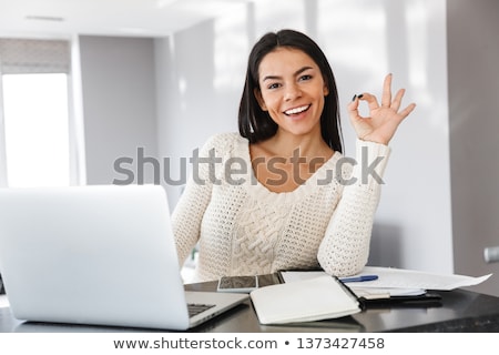 Сток-фото: Young Woman Using Laptop In Kitchen