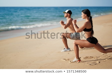 Foto stock: An Athletic Couple Running At Beach
